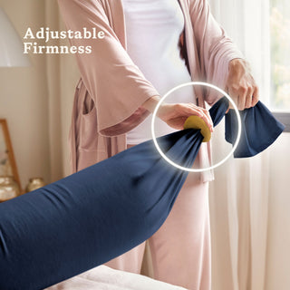 Person adjusting a midnight blue pregnancy pillow with text
