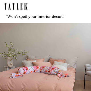 Bedroom with pink bedding and floral pregnancy pillow