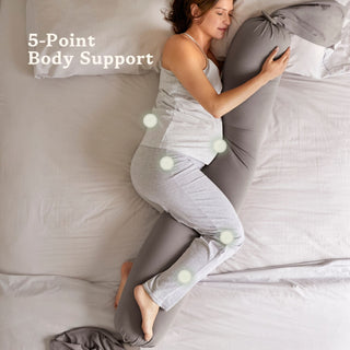 Woman using a bbhugme pregnancy pillow with 