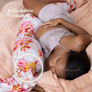 Woman lying on a bed with a bbhugme pregnancy pillow, highlighting adjustable firmness feature.