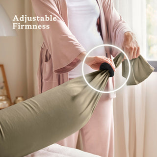 Person adjusting a bbhugme pregnancy pillow with text 