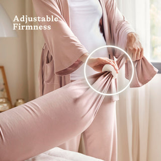 Person adjusting a bbhugme pregnancy pillow with 