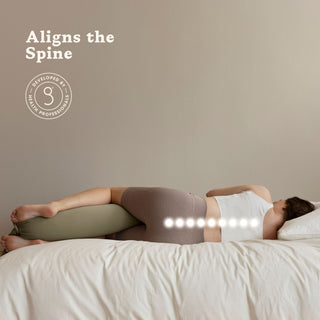 Person lying on a bed with a bbhugme pregnancy pillow under their head, promoting spinal alignment.