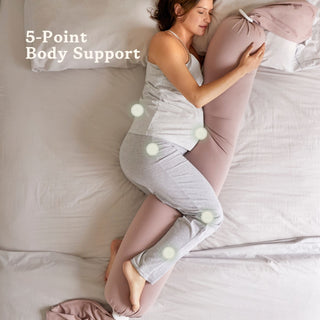 Woman using a bbhugme pregnancy pillow with 