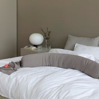 Bedroom with a bed featuring bbhugme pregnancy pillow