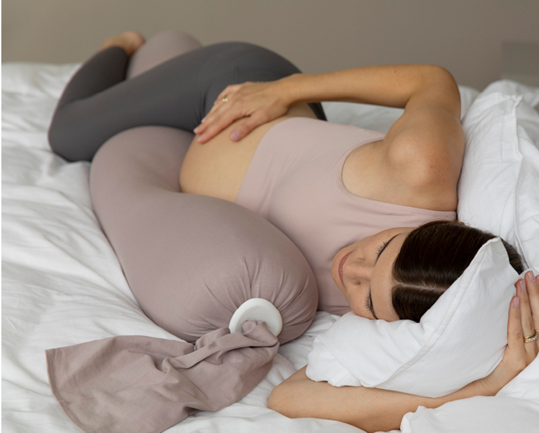 Pregnant woman sleeping with bbhugme pregnancy pillow